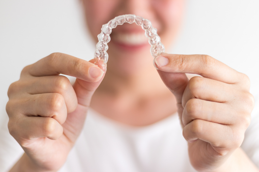 person holding invisalign trays
