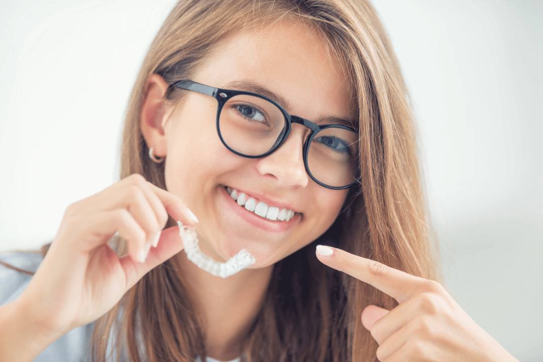 young woman pointing at clear aligners
